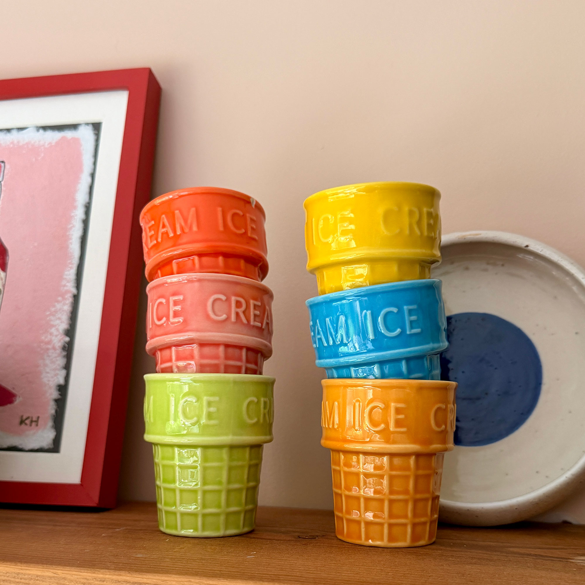 Two stacks of colourful ceramic ice cream cups