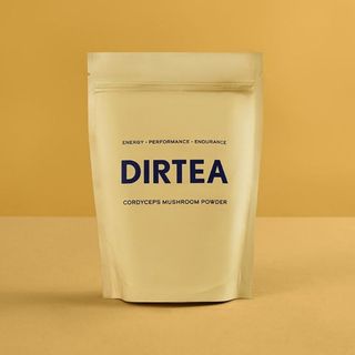 A bag of DIRTEA mushroom coffee with yellow background