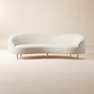Goop designed white curved couch.