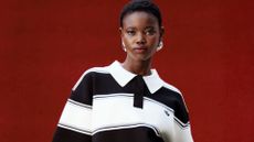 A MODEL WEARING BALCK AND WHITE STRIPED TSHRIT 