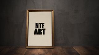 Buying NFTs: a picture frame sits agains a wall with the word NFT inside