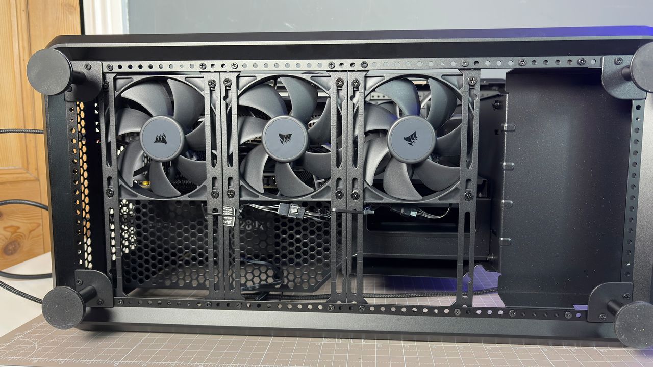 The CoolerMaster MasterFrame 360 Panoramic PC case with various components installed on a desk.