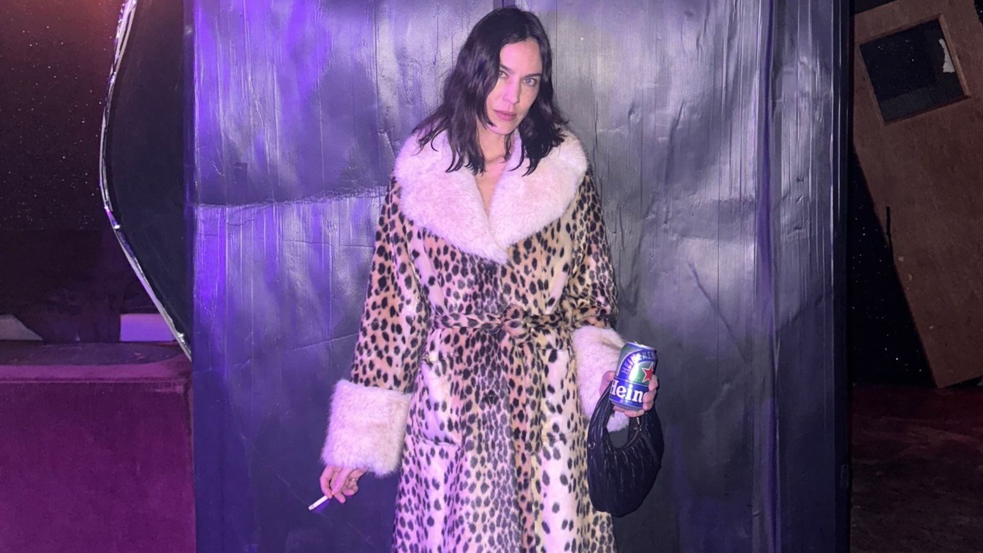 Alexa Chung wears the Queens of Archive Leopard print fur trimmed coat with red high heels and semi sheer tights.