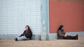 two girls sit on either side of a building in the tv show high school