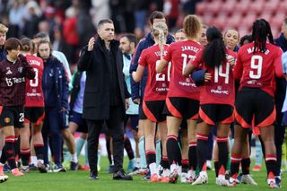 Marc Skinner, Manager of Manchester United, shakes hands with players of Manchester United after the Barclays Women's Super League match between Manchester United and Arsenal at Leigh Sports Village on November 03, 2024 in Leigh, England.