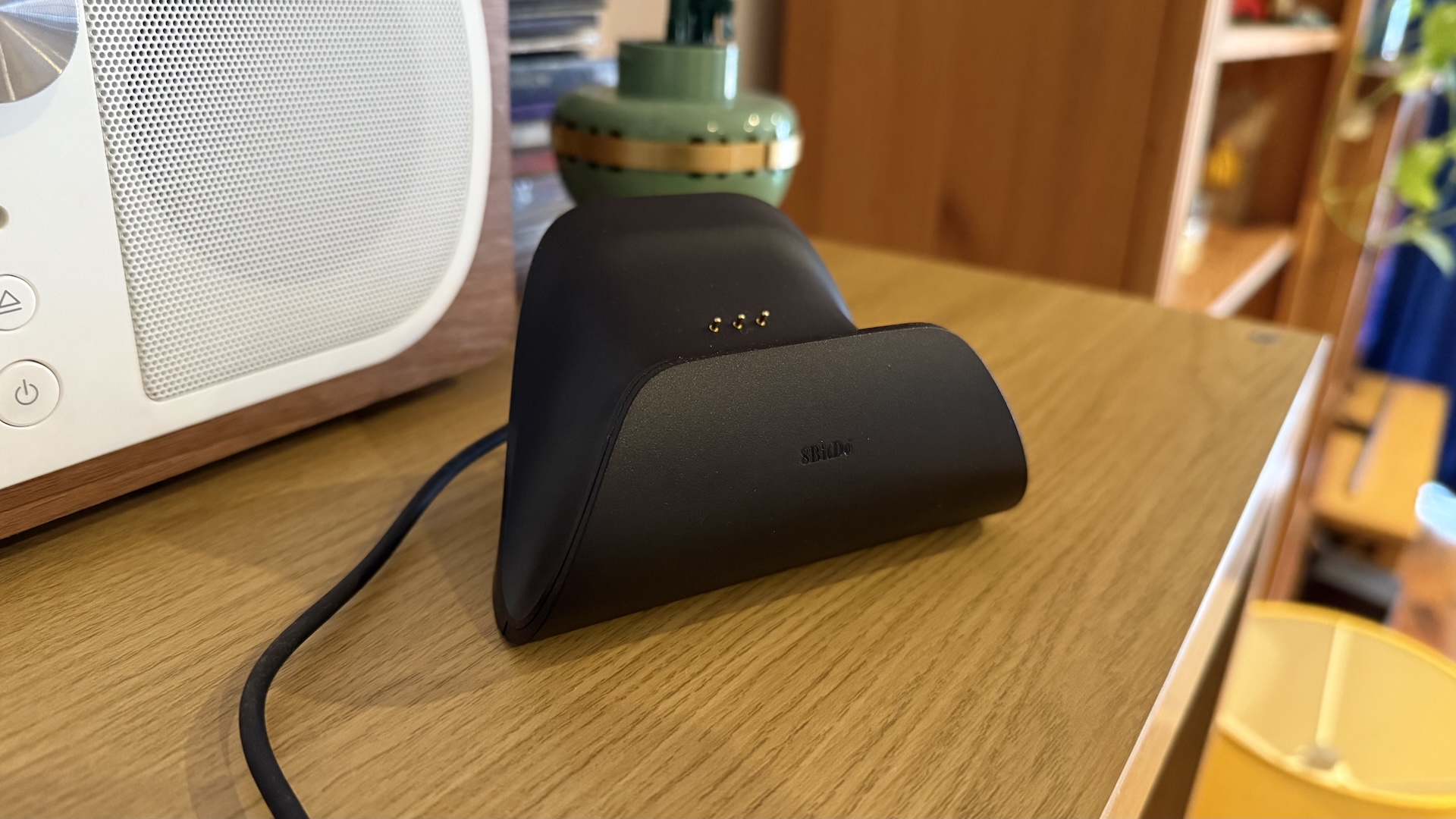 The 8BitDo Ultimate 2 controller, with dock and USB connection at home