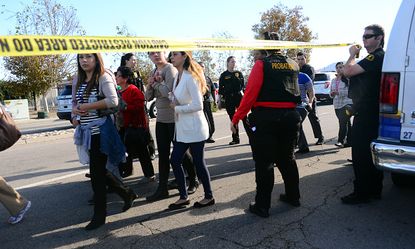 Survivors leave the office building in San Bernardino.
