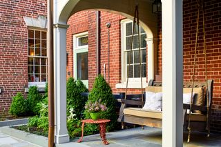 porch swing on backyard patio by Joseph Richardson of Richardson & Associates Landscape Architecture