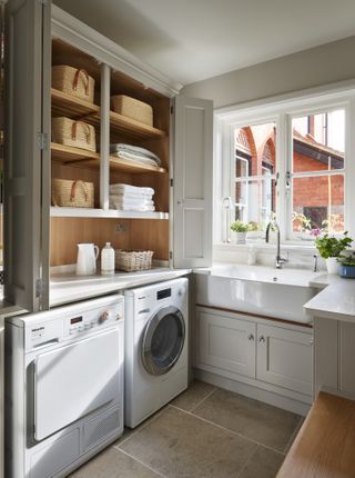 small utility room with open shelving and washing machine