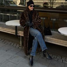 Annabel Rosendahl wears a leopard jacket with blue jeans and black boots.