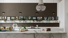 Brown kitchen with open shelving and marble kitchen island