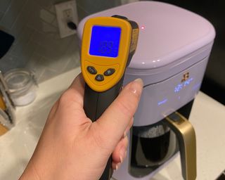 Bailey Cain checking temperature on Beautiful by Drew Barrymore coffee maker