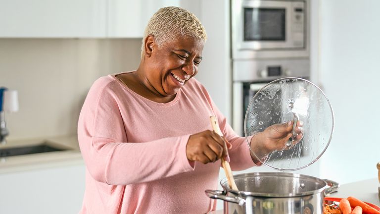 Older woman staying active by cooking