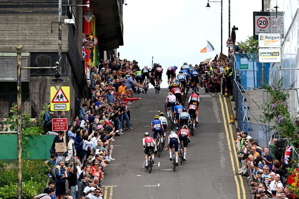 GLASGOW SCOTLAND AUGUST 06 Tadej Pogacar of Slovenia Neilson Powless of The United States Mattias Skjelmose of Denmark Nathan Van Hooydonck of Belgium Lorenzo Rota of Italy Matteo Trentin of Italy Wout Van Aert of Belgium Jhonnatan Narvaez of Ecuador Stefan Kng of Switzerland Rasmus Tiller of Norway Tobias Halland Johannessen of Norway Mathieu Van Der Poel of The Netherlands Jasper Stuyven of Belgium Christophe Laporte of France Sren Kragh Andersen of Denmark Marc Hirschi of Switzerland Dylan Van Baarle of The Netherlands and a general view of the peloton competing during the 96th UCI Cycling World Championships Glasgow 2023 Men Elite Road Race a 2711km one day race from Edinburgh to Glasgow UCIWT on August 06 2023 in Glasgow Scotland Photo by Dario BelingheriGetty Images