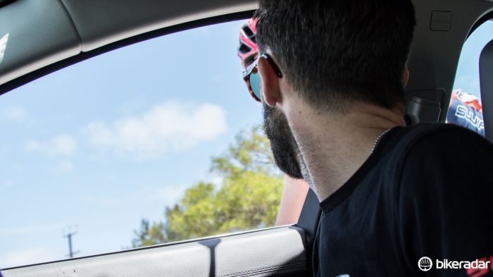 As a rider drops back for a quick feed, Tom Southam takes the time to double check all is well in the peloton and that the team is protecting its day's asset