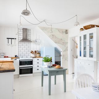 kitchen with white walls white tiled flooring and kitchen shelves