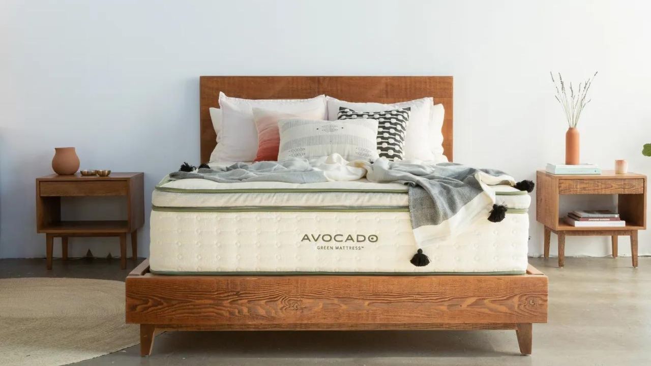 Avocado Green Mattress against a white wall beside two nightstands.