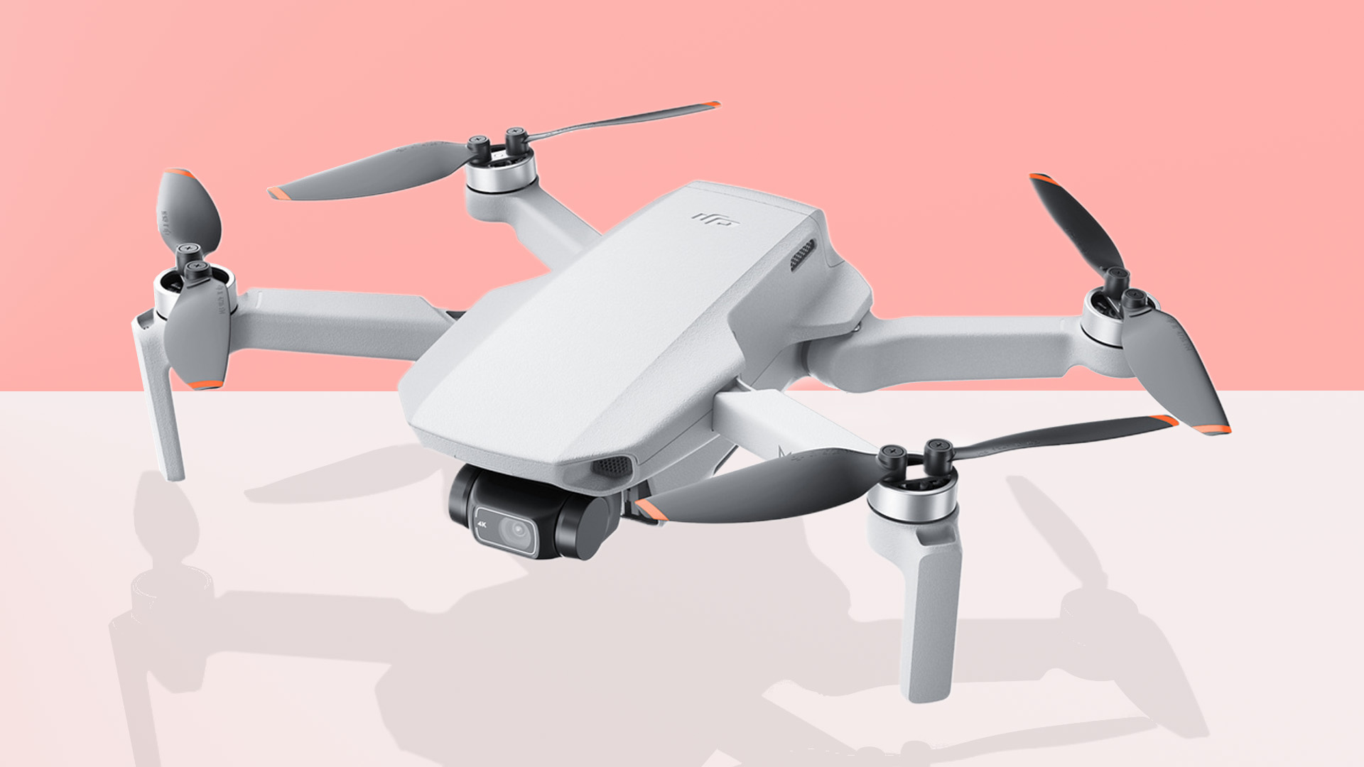 The DJI Mini 2 drone on a pink and grey background