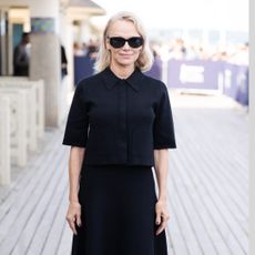 Pamela Anderson in a blonde curled bob hairstyle