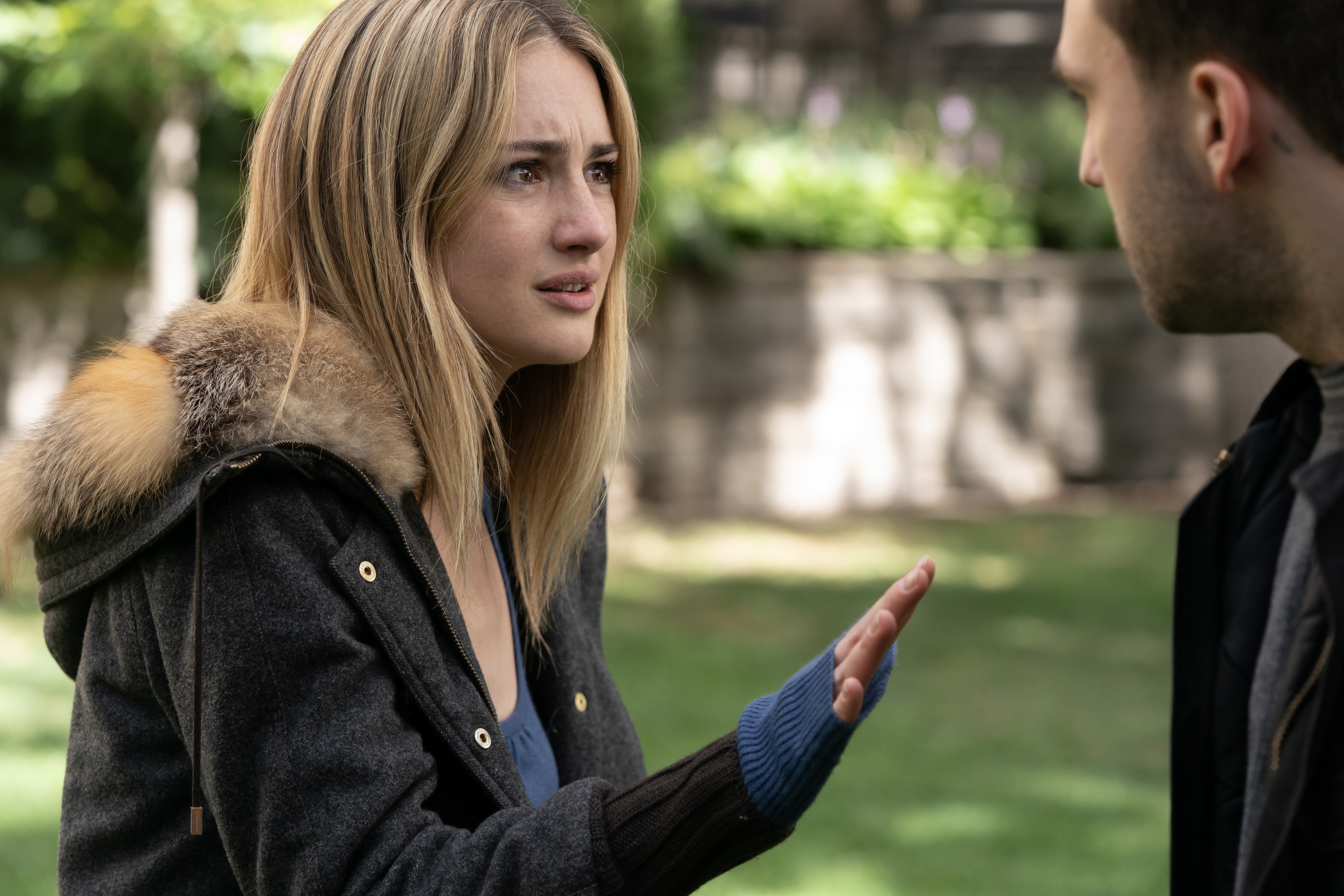 grace van patten as lucy wearing a fur lined coat yelling at jackson white as jackson on campus in the tell me lies finale