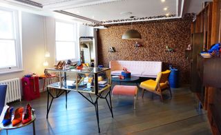a colourful mix of vintage and custom made furniture, including a pair of bright blue and white Gio Ponti armchairs, re-edited by Molteni, Jean Prouvé’s Cite chair, a pink velvet vintage armchair, and a Mayor of London pink sofa