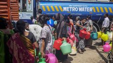 Residents wait in line to fill pots from a water truck in Chennai, India, on Thursday, July 4, 2019. 