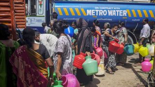 Residents wait in line to fill pots from a water truck in Chennai, India, on Thursday, July 4, 2019.