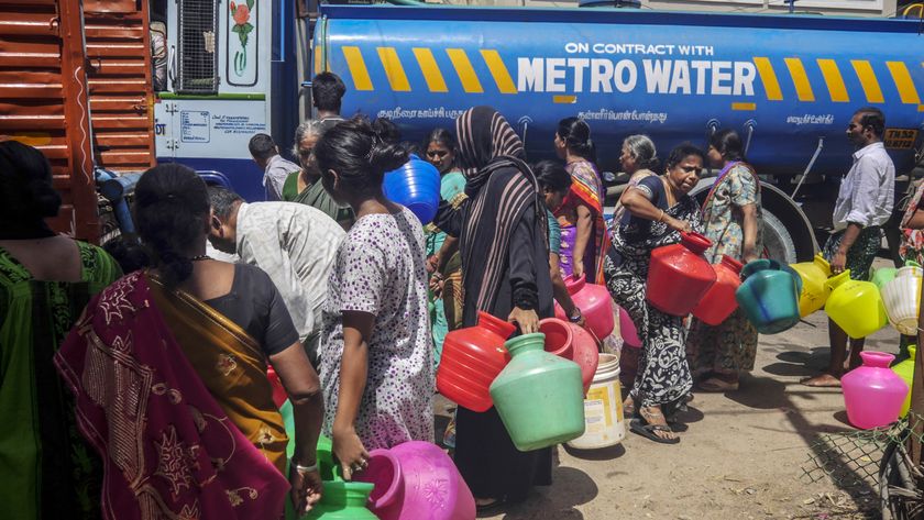 Residents wait in line to fill pots from a water truck in Chennai, India, on Thursday, July 4, 2019. 