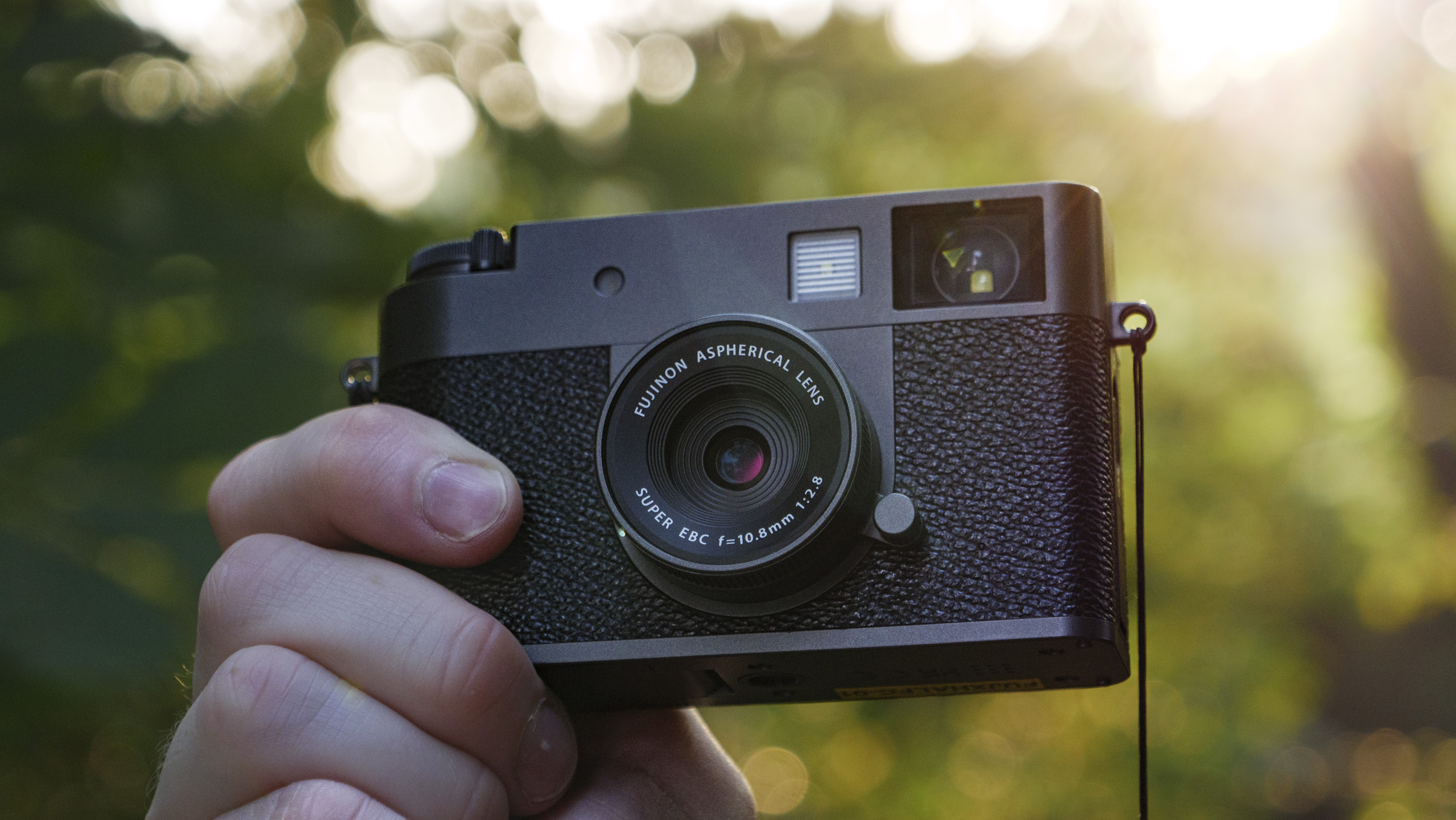 Fujifilm X half camera in the hand at golden hour
