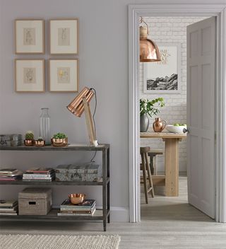narrow hallway with console table and wall art