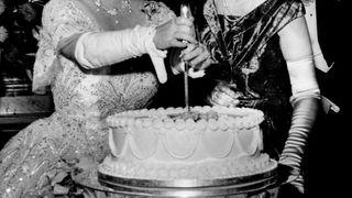Queen Elizabeth, the Queen Mother, cutting the birthday cake of the Women's Group
