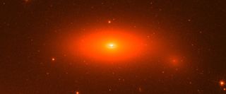 This image shows the disk galaxy NGC 1277, as seen by the Hubble Space Telescope. The small, flattened galaxy has one of the biggest central super-massive black holes ever found in its center. 