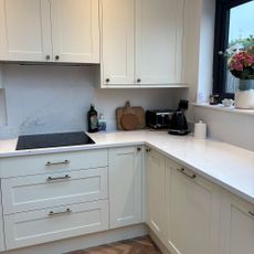 White kitchen with marble effect counter and splashback
