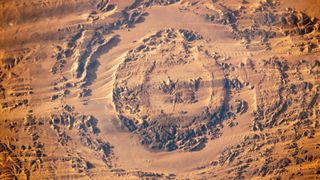 A satellite photo of an impact crater in the shape of an eye