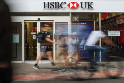 Pedestrians walking past a HSBC high street branch