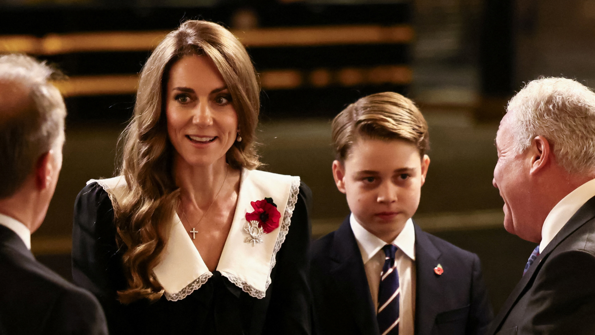 Kate Middleton wears a black dress with a large white collar and is accompanied by eldest son Prince George at the Royal British Legion Festival of Remembrance at the Royal Albert Hall in London