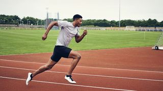 Man running on athletics track