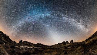 A 200+ degree panorama of the arch of the winter Milky Way, from south left to northwest ar right with the Zodiacal Light to the west at centre This was from Dinosaur Provincial Park in southern Alberta on February 28, 2017 A spell of warm weather left very little snow, so the landscape does not look like winter here But the sky is! This is a stitch of 6 segments but warped with fish-eye projection so that only 3 or 4 segments are contributing to this image Stitched with PTGui Each segment was 30 seconds at f/28 with the Rokinon 12mm lens and Nikon D750 at ISO 6400 Nik Dfine and Topaz noise reduction applied.