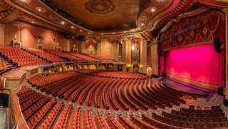 Warner Theatre, shown alit for an upcoming performance, modernized the sonic experience with JBL Professional speaker system.
