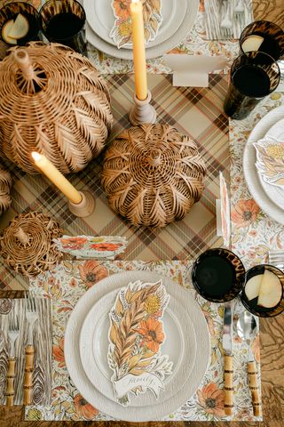 fall tablescape with paper placemats, runner and place holders, bamboo cutlery and rattan pumpkins