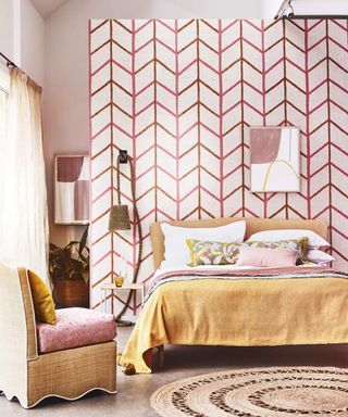 A boho inspired pink master bedroom with statement wallpaper and jute/rattan furnishings