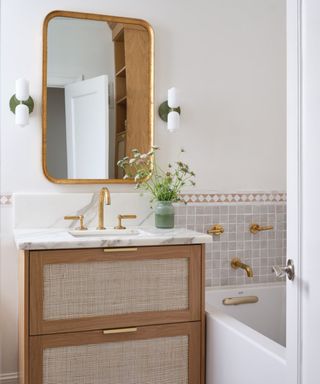 Modern Spanish bathroom with a wooden cabinet and patterned tiles