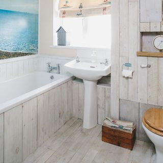 bathroom with wooden panelling on walls, floor and bath