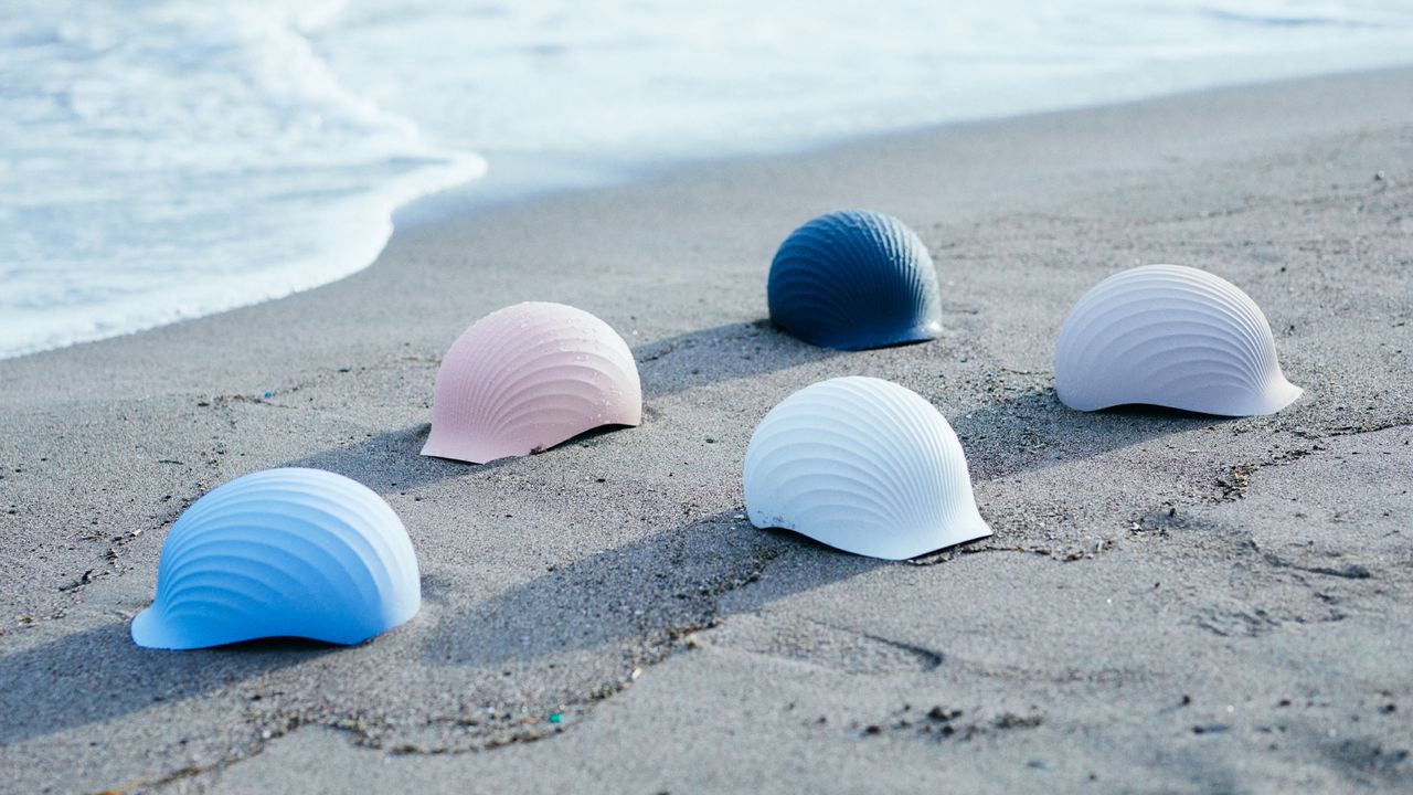 Shellmet in different colours on a beach, resembling shells