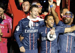 David Beckham and Lucas Moura of Paris Saint-Germain celebrates after defeating Stade Brestois 29 at the French League 1 match at Parc des Princes on May 18, 2013 in Paris, France.