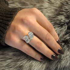 Close up of woman's hand, wearing silver Ritani ring with fur background