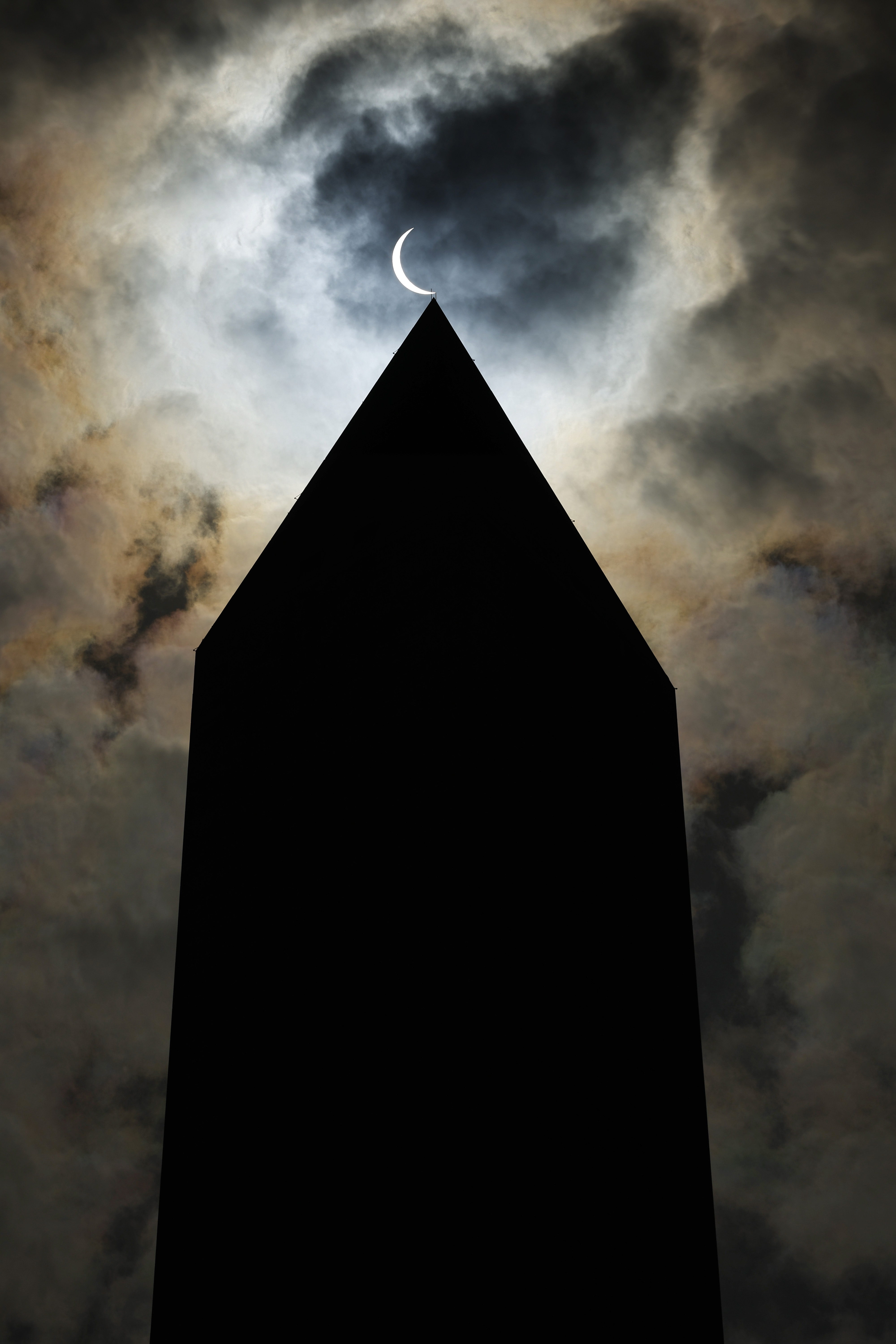 A solar eclipse is seen over the Washington Monument on April 08, 2024 in Washington, DC.
