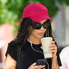 Zo&euml; Kravitz wears a red Sex and the City baseball cap, blue Adidas shorts, and rubber slides on August 28, 2026 in New York City