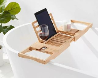 Bathtub caddy with glass of wine and iPad