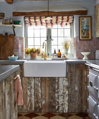 typical english kitchen with rustic wood cabinets and reclaimed materials